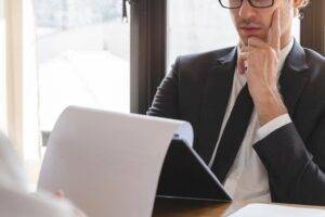 A hiring manager reviewing candidate documents, representing direct hire recruiting myths.