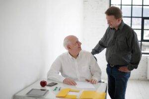 Direct hire recruiter discussing a search with a client, representing why recruiters turn down searches